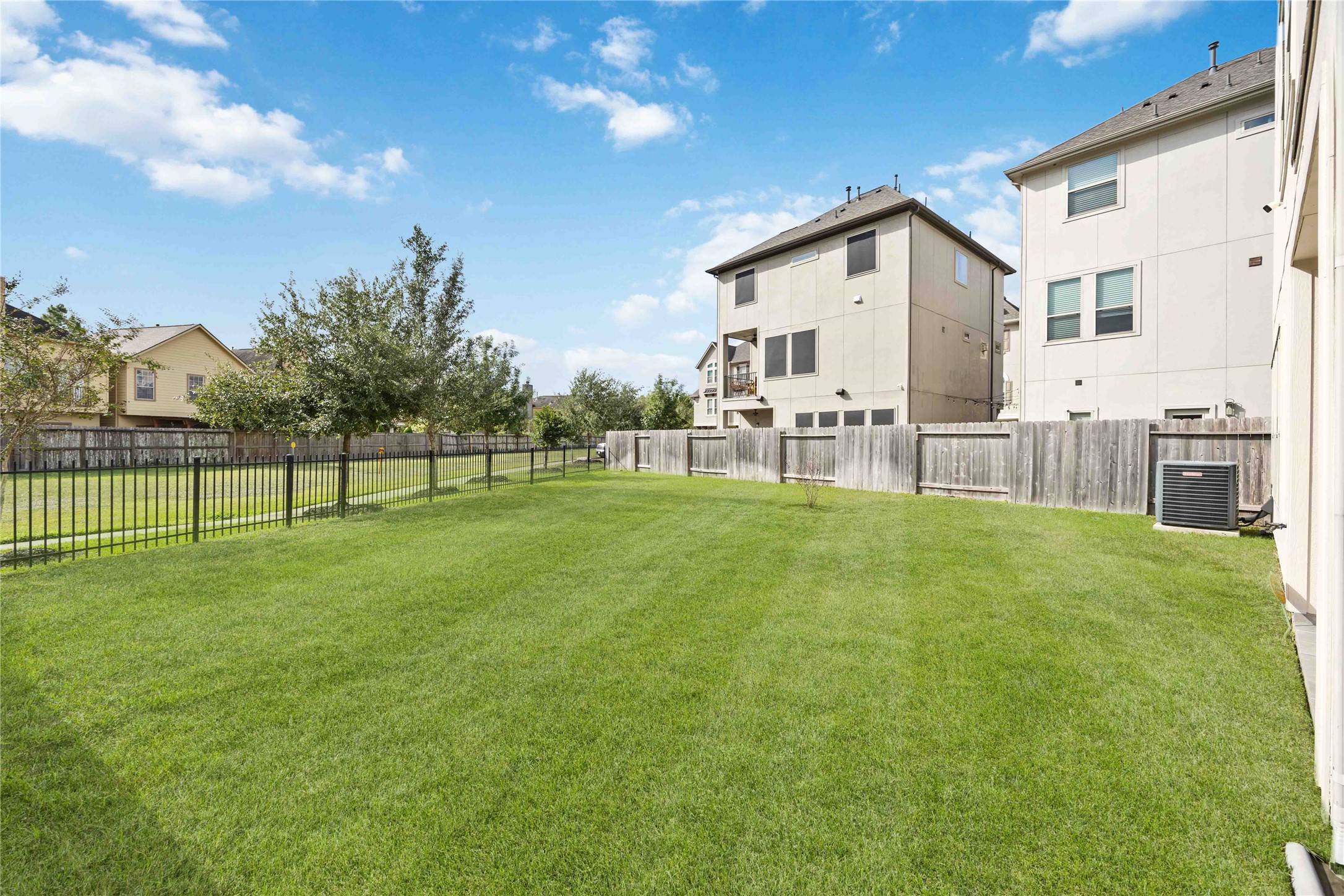 2004 Round Table Trail Houston, TX 77045 - Photo 20 of 20 Spacious backyard with a neatly trimmed lawn and privacy fencing.
