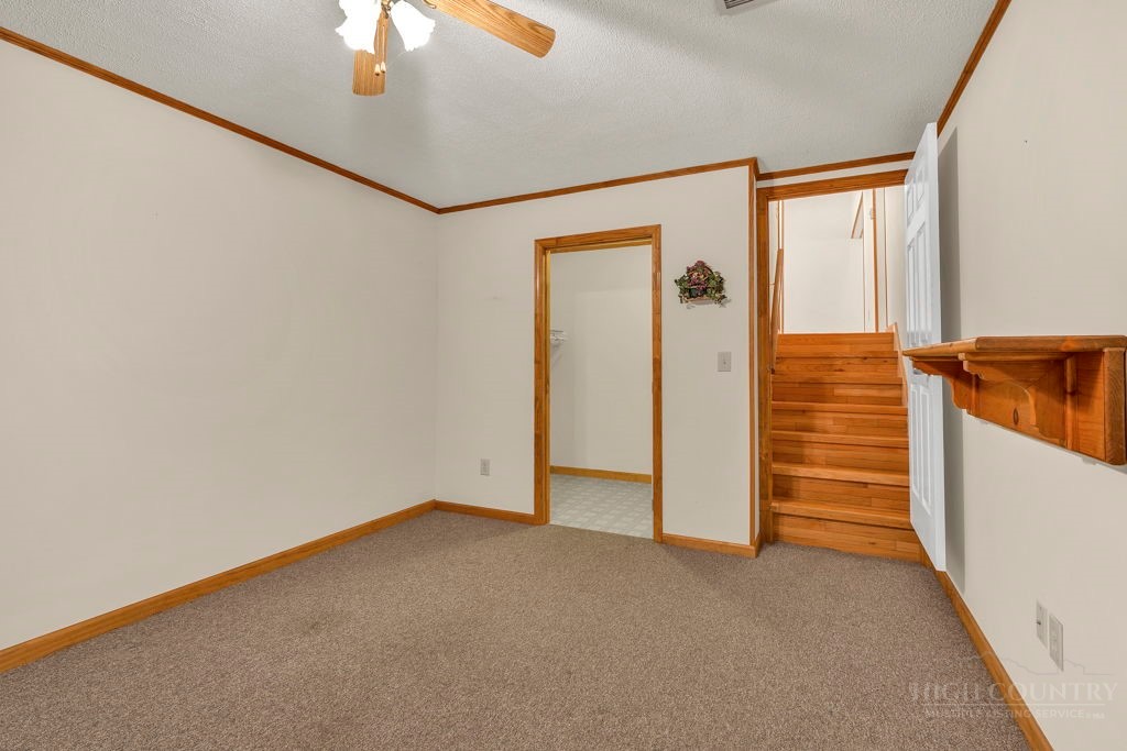 163 Rolling Hill Drive Boone, NC 28607 - Photo 27 of 40 an empty room with a ceiling fan