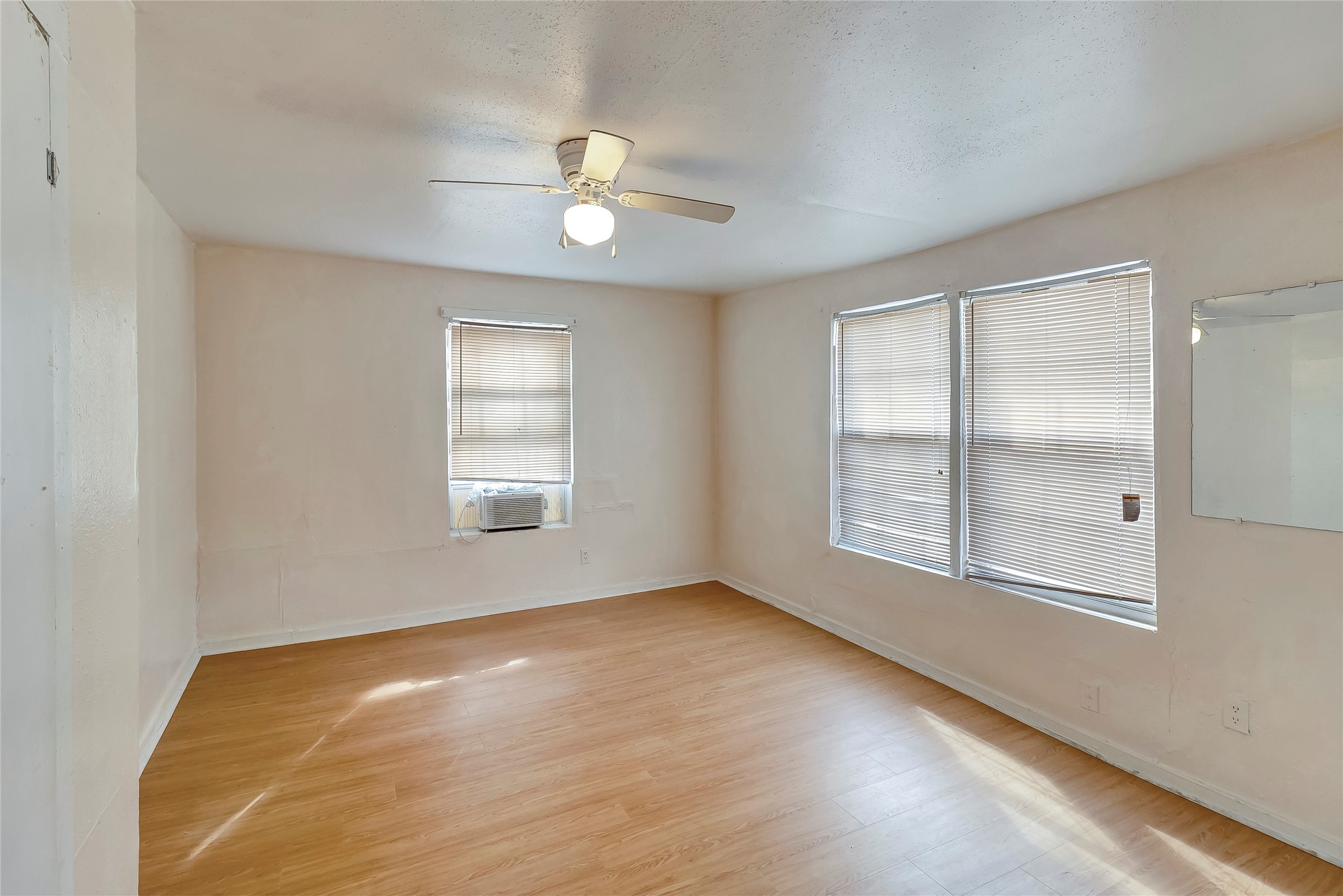 4233 Du Pont Street, Unit A Houston, TX 77021 - Photo 8 of 11 This bedroom features custom paint, ceiling fan with lighting and large windows.