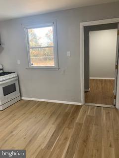 223 Kinsley Road Pemberton, NJ 08068 - Photo 2 of 12 an empty room with wooden floor cabinet and windows