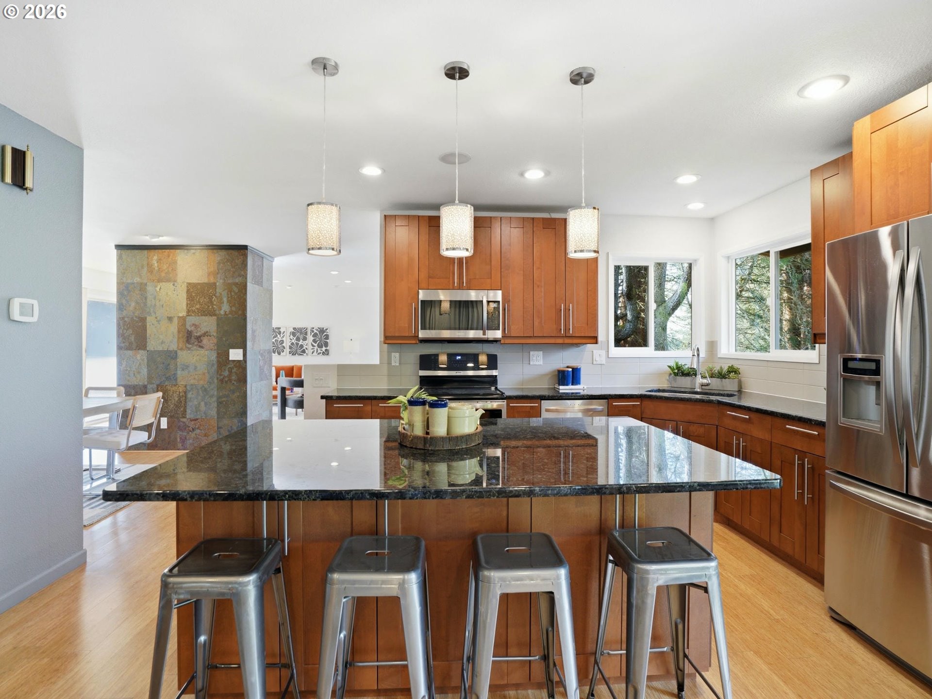 4148 Southwest 43rd Avenue Portland, OR 97221 - Photo 12 of 44 a kitchen with a table chairs refrigerator and microwave