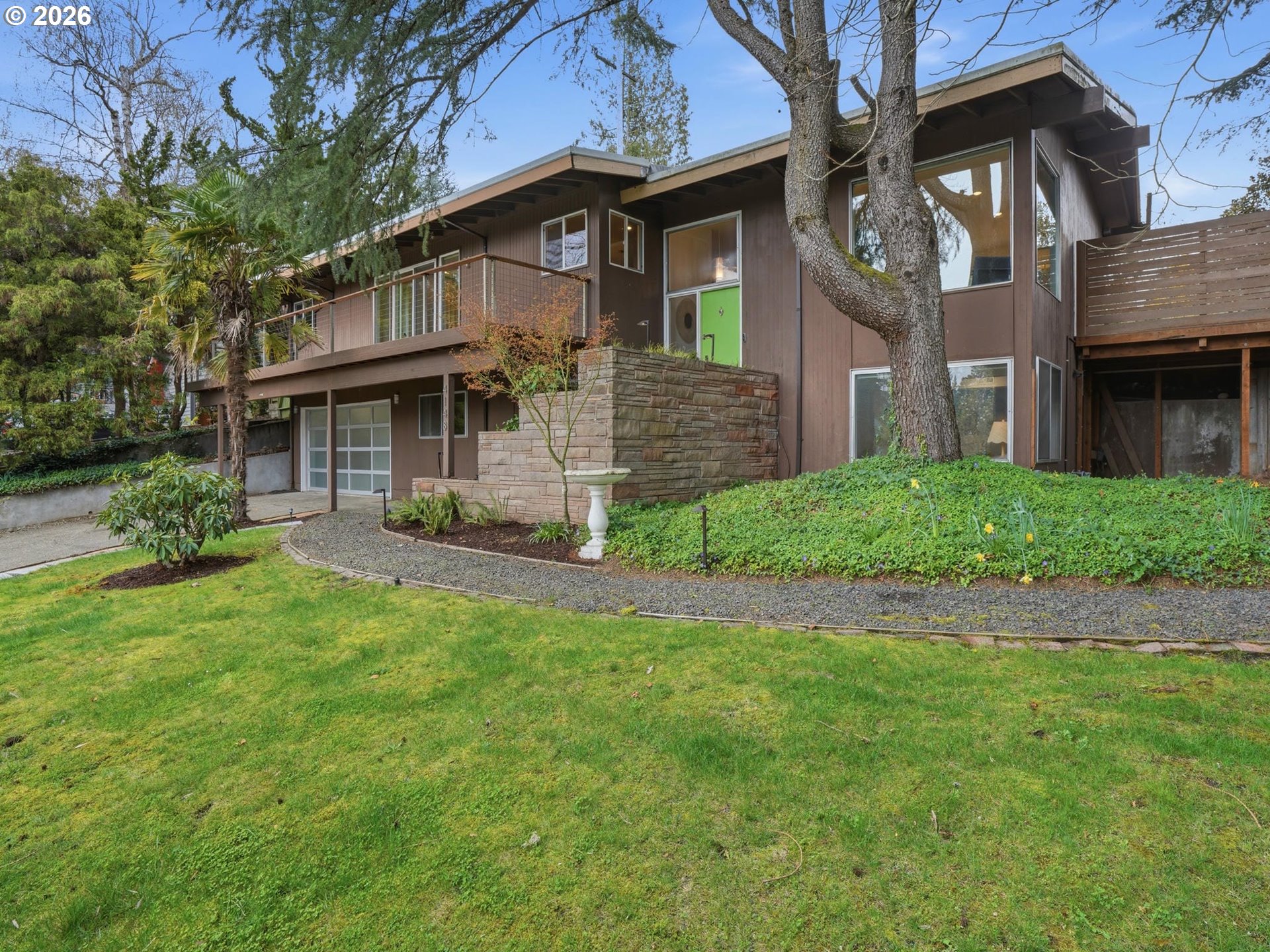 4148 Southwest 43rd Avenue Portland, OR 97221 - Photo 2 of 44 a front view of a house with a yard and garage