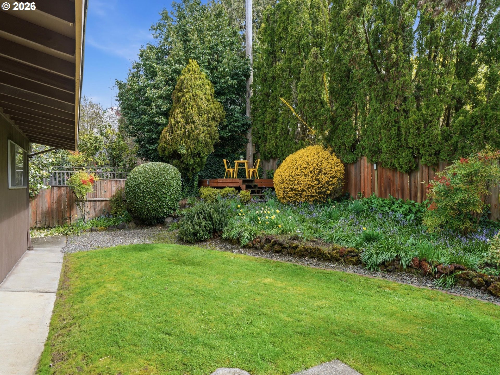 4148 Southwest 43rd Avenue Portland, OR 97221 - Photo 32 of 44 a view of a garden with plants and large trees