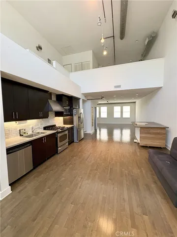 a large kitchen with stainless steel appliances kitchen island granite countertop a sink and cabinets