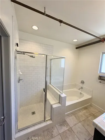a spacious bathroom with a bathtub and a shower