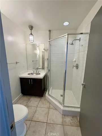 a bathroom with a double vanity sink toilet and shower