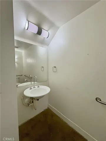 a bathroom with a sink a toilet and mirror
