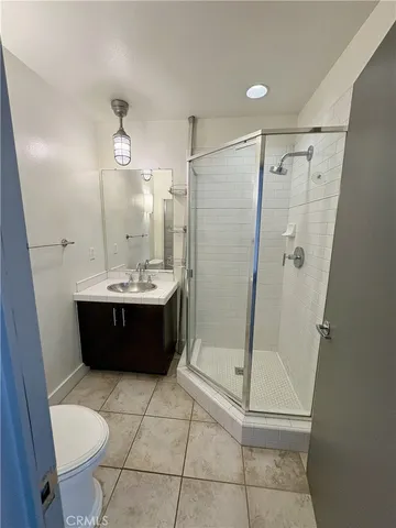 a bathroom with a double vanity sink toilet and shower