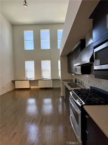 a kitchen with stainless steel appliances a stove a sink and a microwave