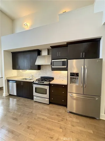 a kitchen with stainless steel appliances a refrigerator and a stove