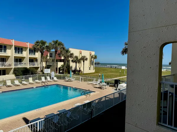a view of a swimming pool with outdoor seating