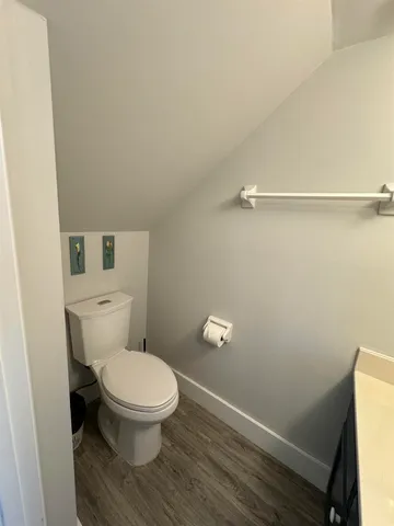 a white toilet sitting next to a small sink