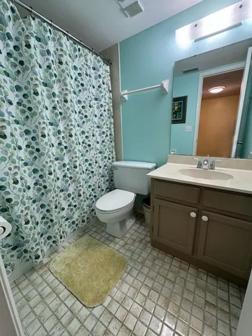 a bathroom with a sink toilet and mirror