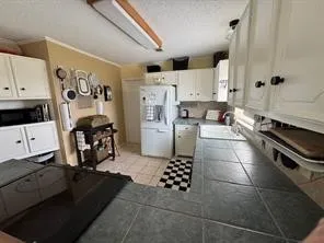 a kitchen with stainless steel appliances kitchen island granite countertop a refrigerator and a stove