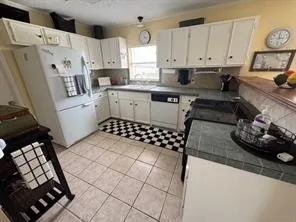 a kitchen with stainless steel appliances a stove a sink and a refrigerator