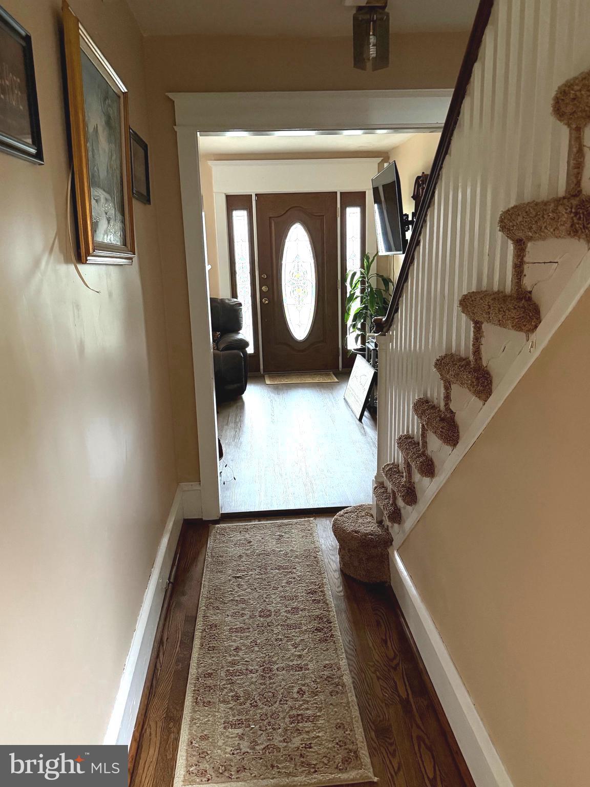 463 Burmont Road Drexel Hill, PA 19026 - Photo 5 of 39 a view of a hallway with wooden floor and staircase