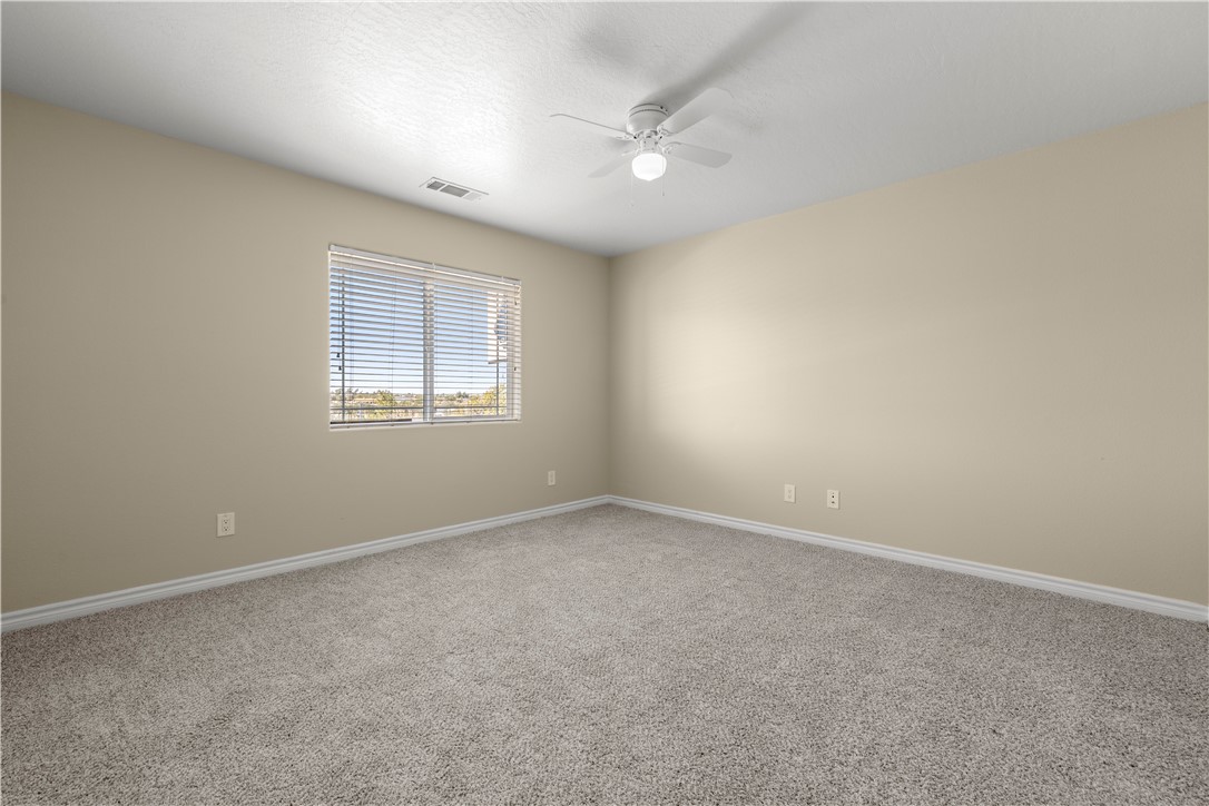 8755 Lilac Road Oak Hills, CA 92344 - Photo 15 of 28 an empty room with windows and closet
