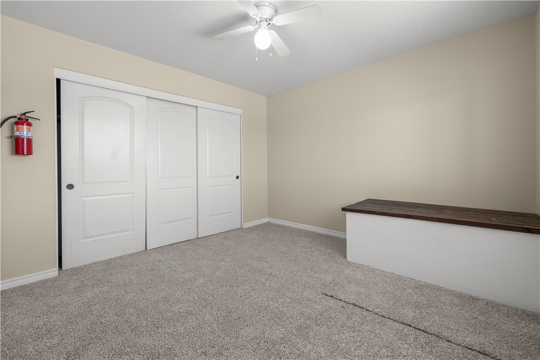 8755 Lilac Road Oak Hills, CA 92344 - Photo 17 of 28 an empty room with a ceiling fan and a window