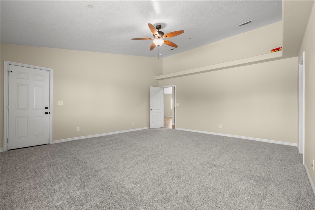 8755 Lilac Road Oak Hills, CA 92344 - Photo 20 of 28 an empty room with a ceiling fan and a window