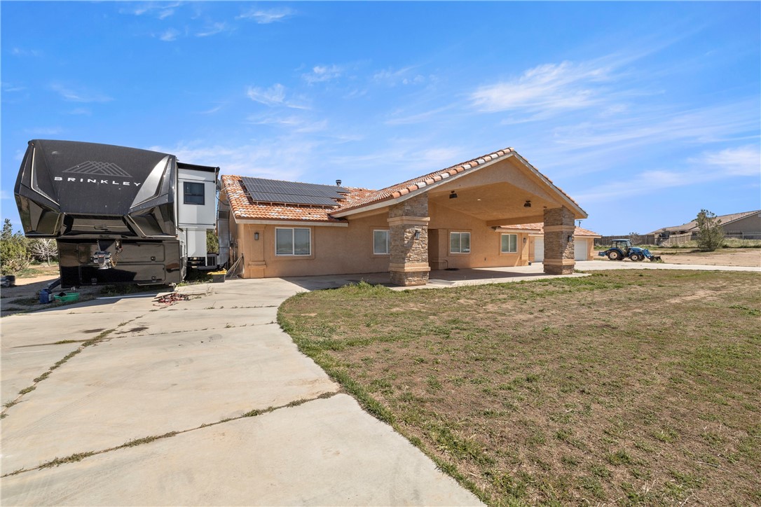 8755 Lilac Road Oak Hills, CA 92344 - Photo 24 of 28 a front view of a house with a garden
