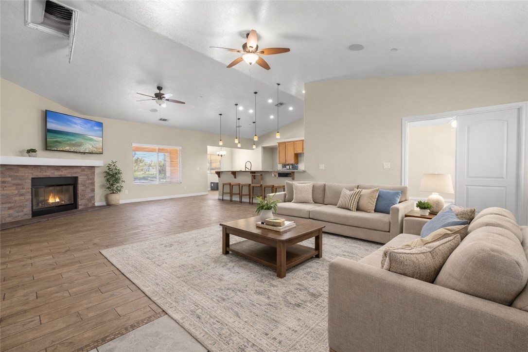 8755 Lilac Road Oak Hills, CA 92344 - Photo 3 of 28 a living room with furniture and a fireplace