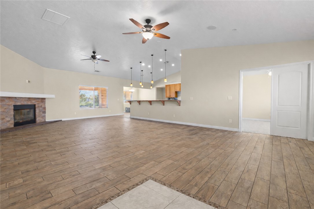 8755 Lilac Road Oak Hills, CA 92344 - Photo 4 of 28 wooden floor in an empty room with a fireplace
