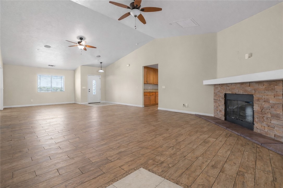 8755 Lilac Road Oak Hills, CA 92344 - Photo 6 of 28 an empty room with windows and fireplace