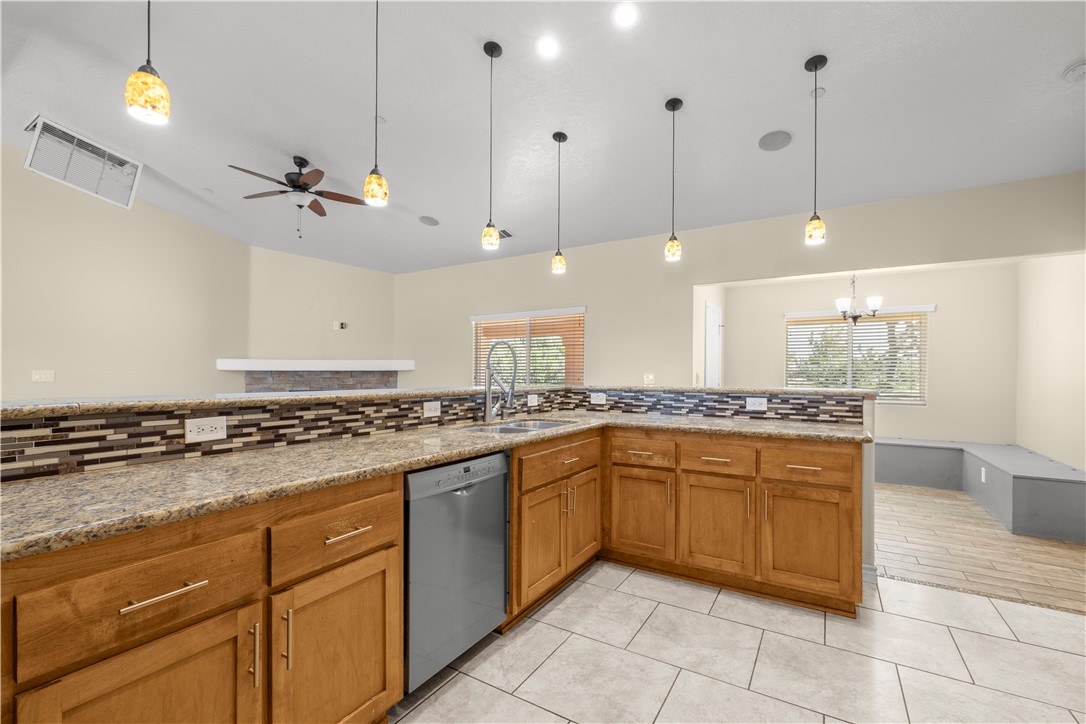 8755 Lilac Road Oak Hills, CA 92344 - Photo 7 of 28 a kitchen with a sink a stove top oven and cabinets