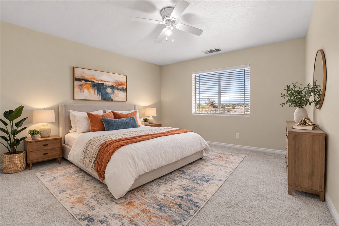 8755 Lilac Road Oak Hills, CA 92344 - Photo 10 of 28 a bedroom with bed and window
