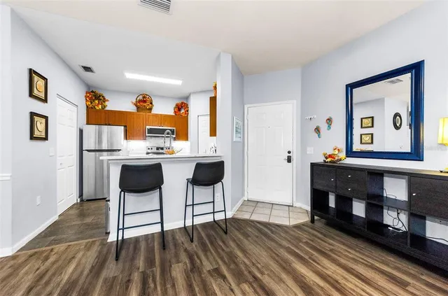 a dining room with furniture a large window and a chandelier