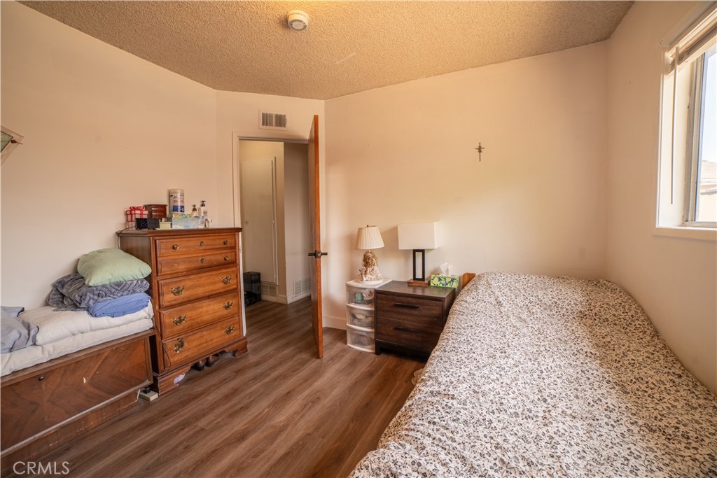 9418 East Duarte Road Arcadia, CA 91007 - Photo 16 of 21 a bedroom with a bed and wooden floor