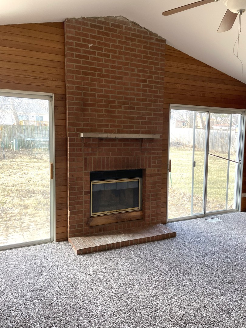 1740 Cumberland Road Aurora, IL 60504 - Photo 17 of 37 a view of an empty room with a fireplace and a window