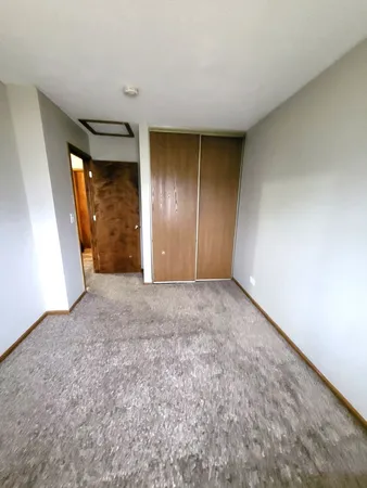 a view of an empty room and a window