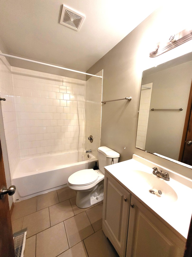 1740 Cumberland Road Aurora, IL 60504 - Photo 24 of 37 a bathroom with a sink a toilet a mirror and shower