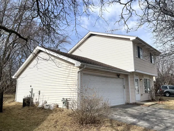 a view of a house with a yard and garage