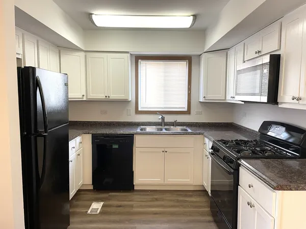 a kitchen with a refrigerator stove and sink