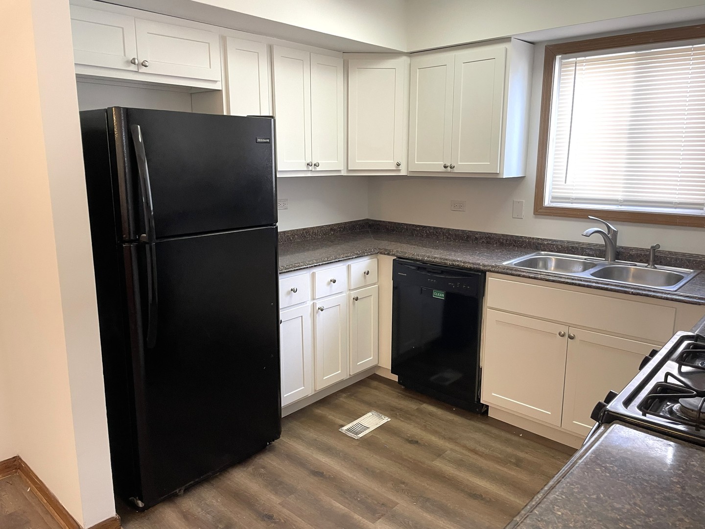1740 Cumberland Road Aurora, IL 60504 - Photo 7 of 37 a kitchen with a refrigerator sink and cabinets