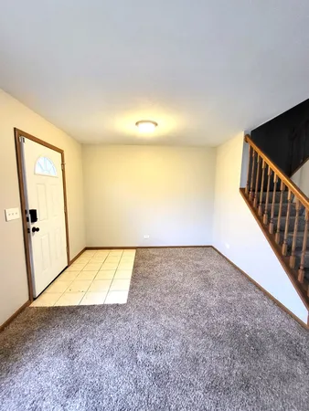 a view of an empty room and wooden floor