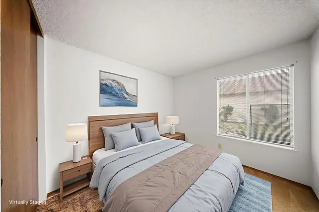 a bedroom with a bed and a window