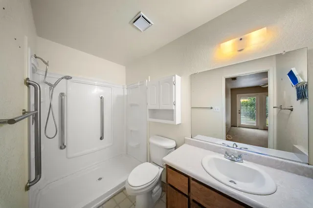 a bathroom with a sink toilet and shower