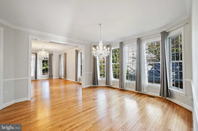 a kitchen with stainless steel appliances granite countertop wooden cabinets a stove top oven and a sink