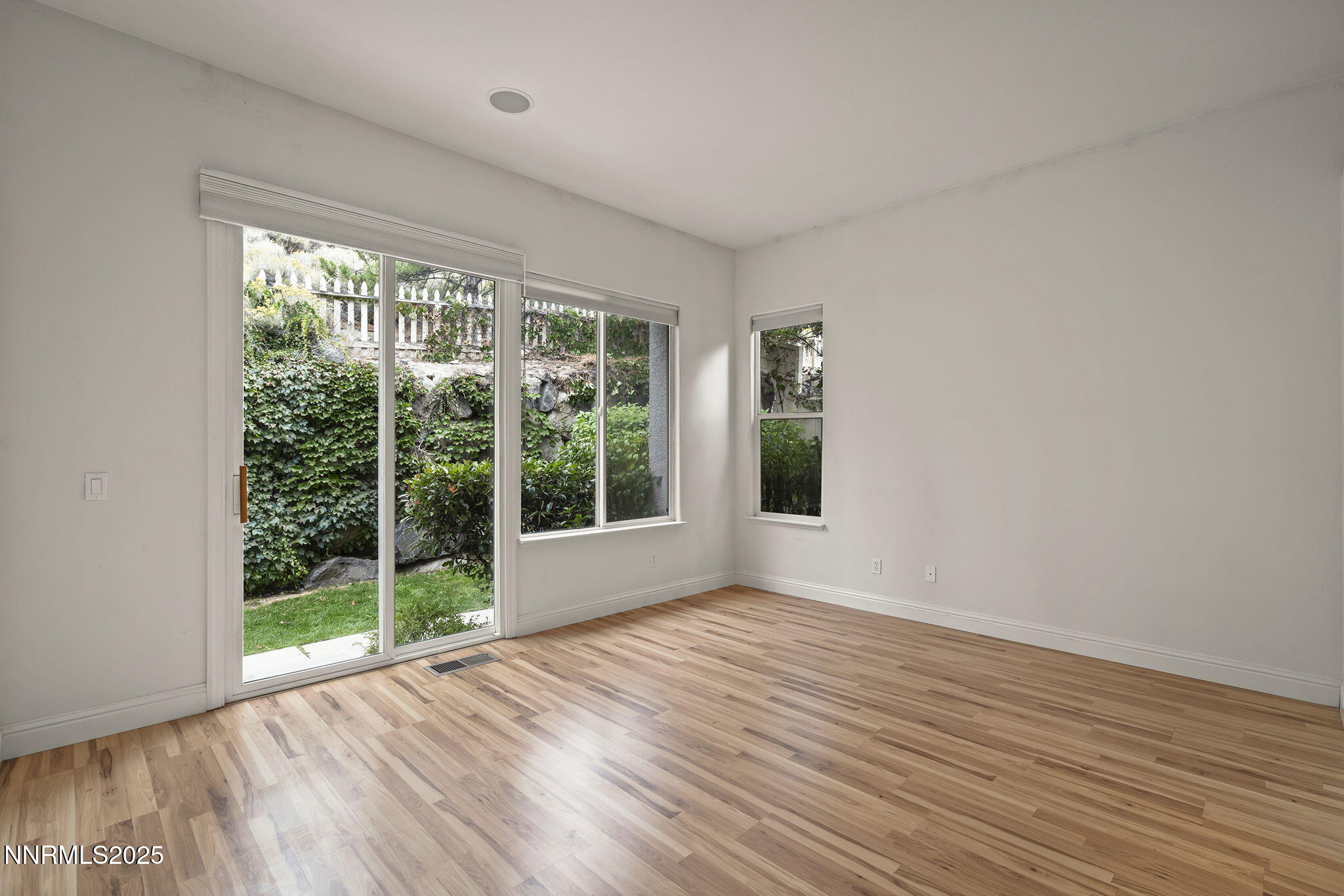 1720 Hunter Creek Road Reno, NV 89519 - Photo 12 of 21 a view of an empty room with wooden floor and a window