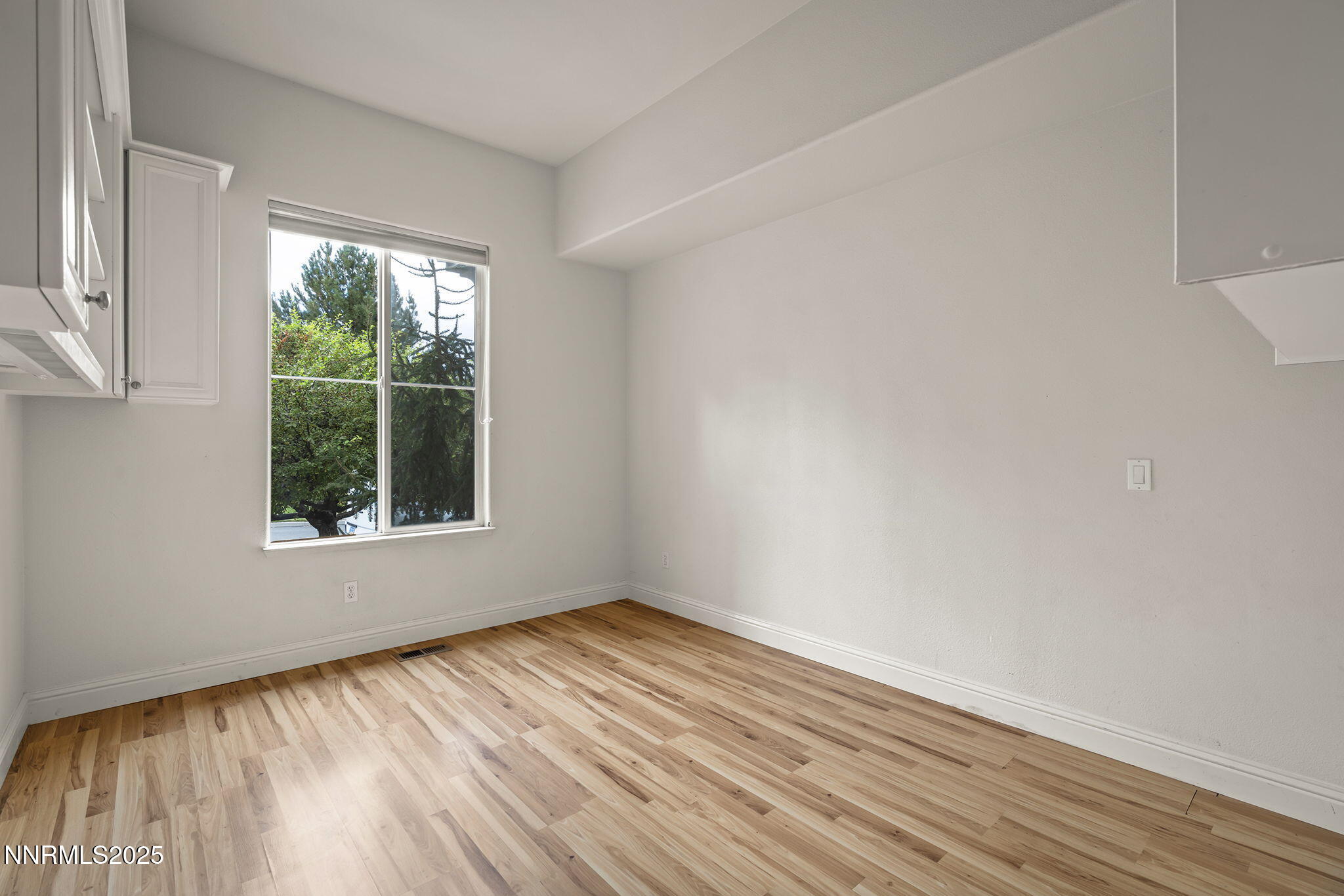 1720 Hunter Creek Road Reno, NV 89519 - Photo 15 of 21 a view of an empty room with wooden floor and a window