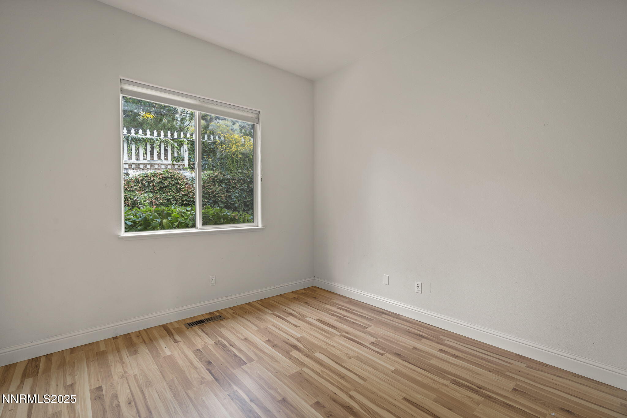 1720 Hunter Creek Road Reno, NV 89519 - Photo 16 of 21 an empty room with wooden floor and windows