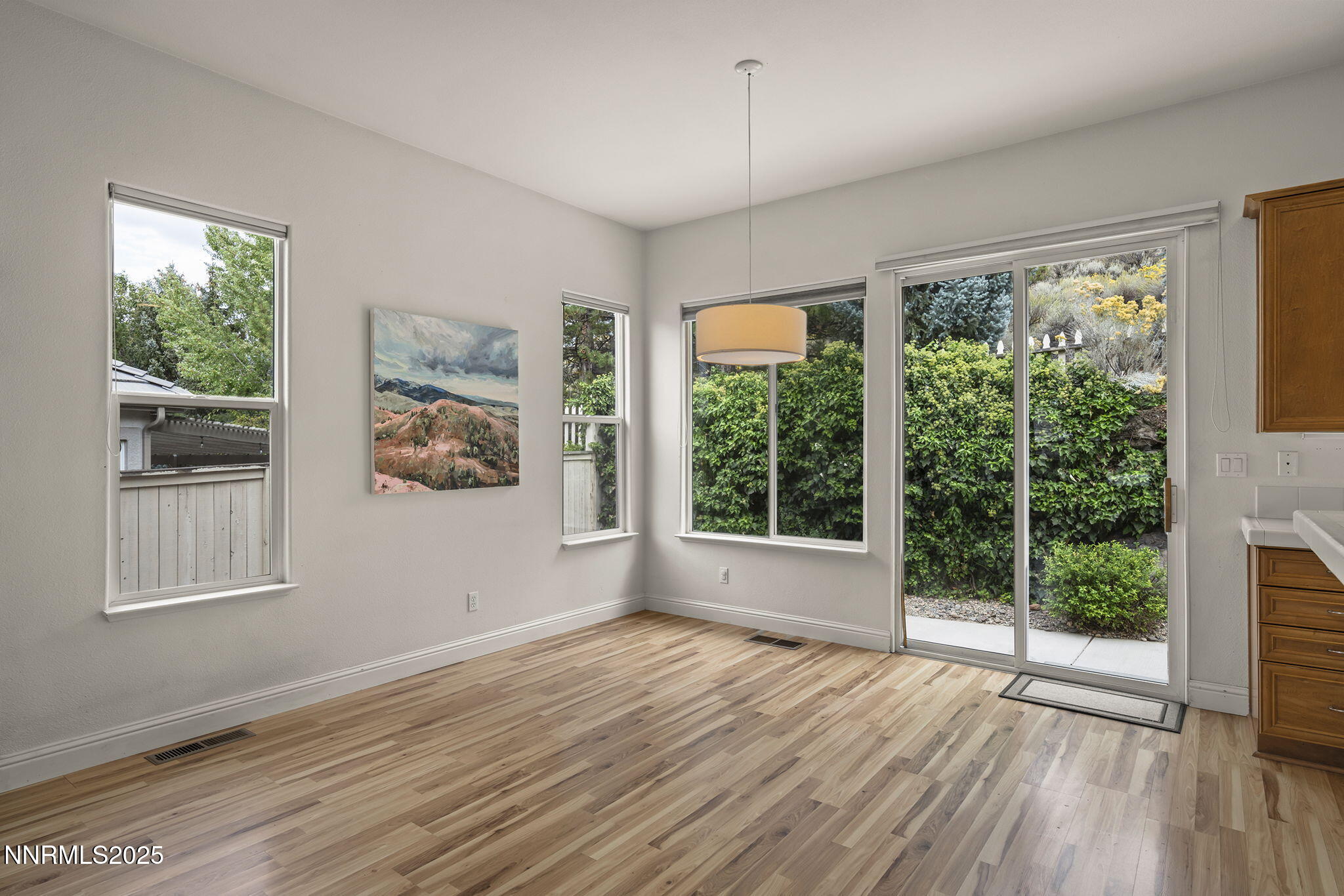 1720 Hunter Creek Road Reno, NV 89519 - Photo 8 of 21 a view of an empty room with wooden floor and a window