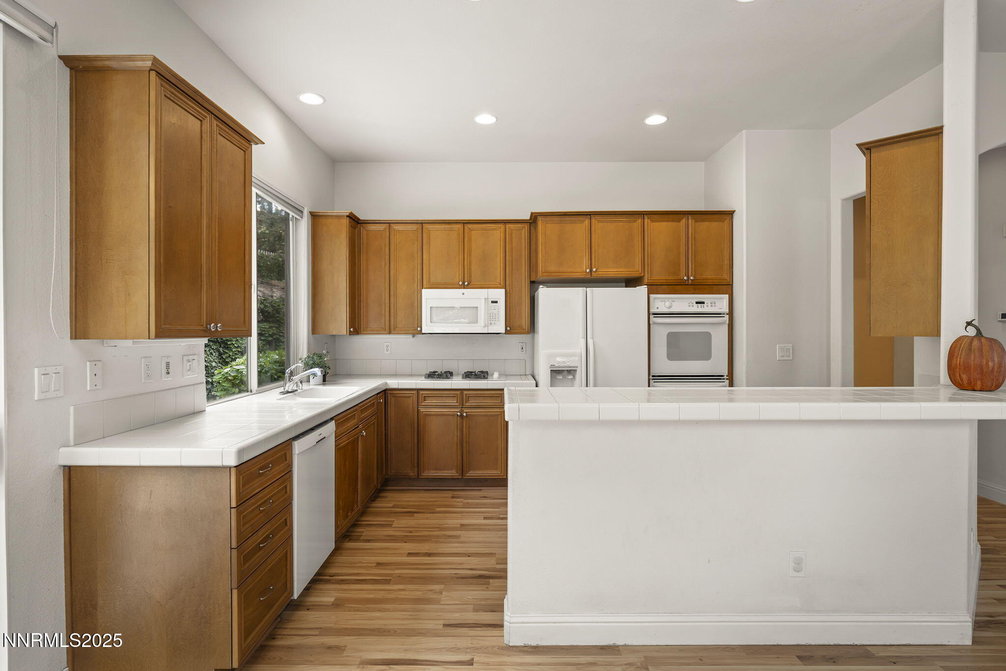 1720 Hunter Creek Road Reno, NV 89519 - Photo 9 of 21 a kitchen with stainless steel appliances granite countertop a sink and a refrigerator