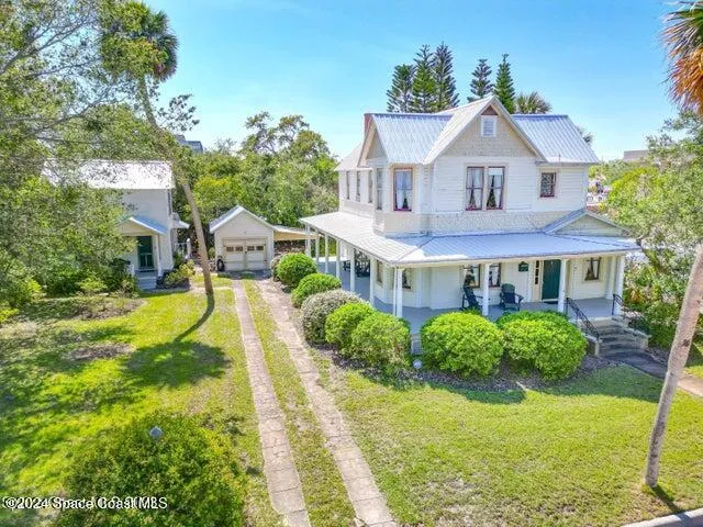 a front view of a house with yard and green space