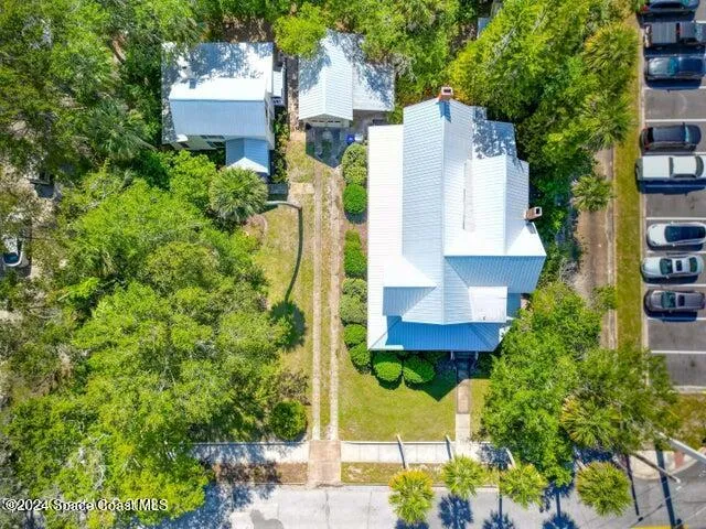 a aerial view of a house with a yard and garden
