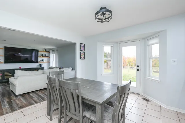 a metallic refrigerator freezer sitting in a kitchen