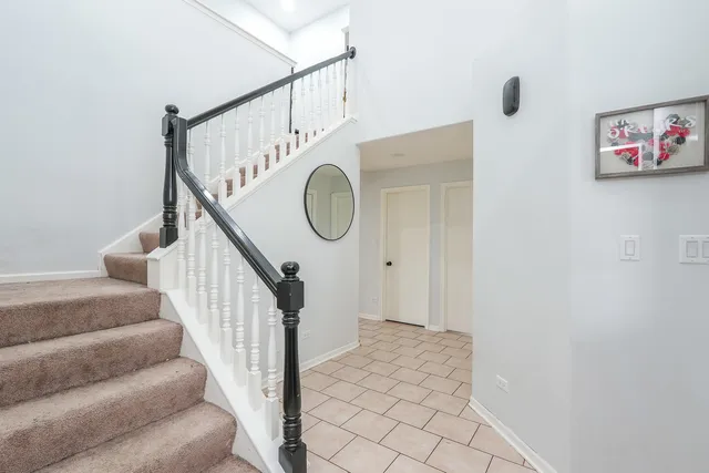a view of staircase with white walls and a window